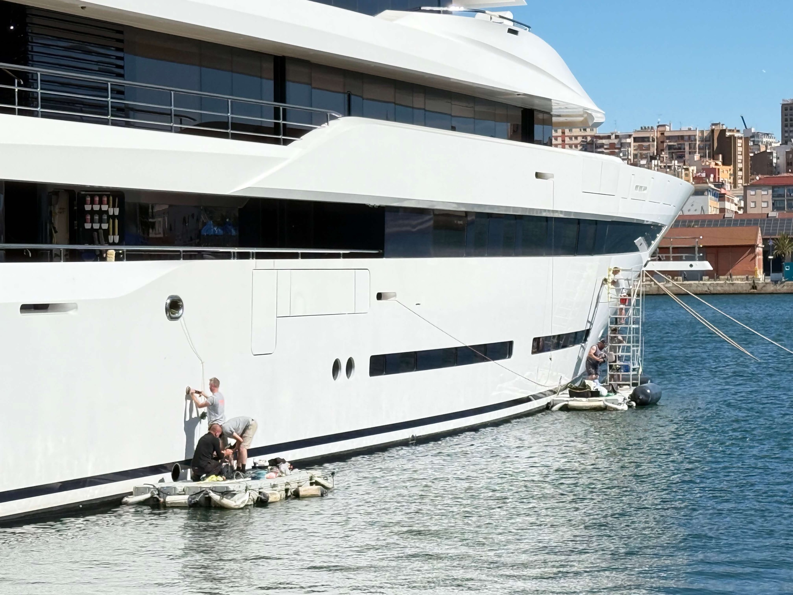 A superyacht alongside in Barcelona with an RMP Marine technician working on the passerelle.