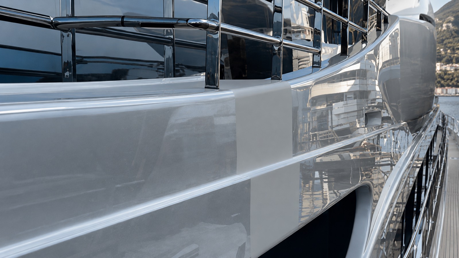 Sunlight across the freshly protected topsides of a superyacht.
