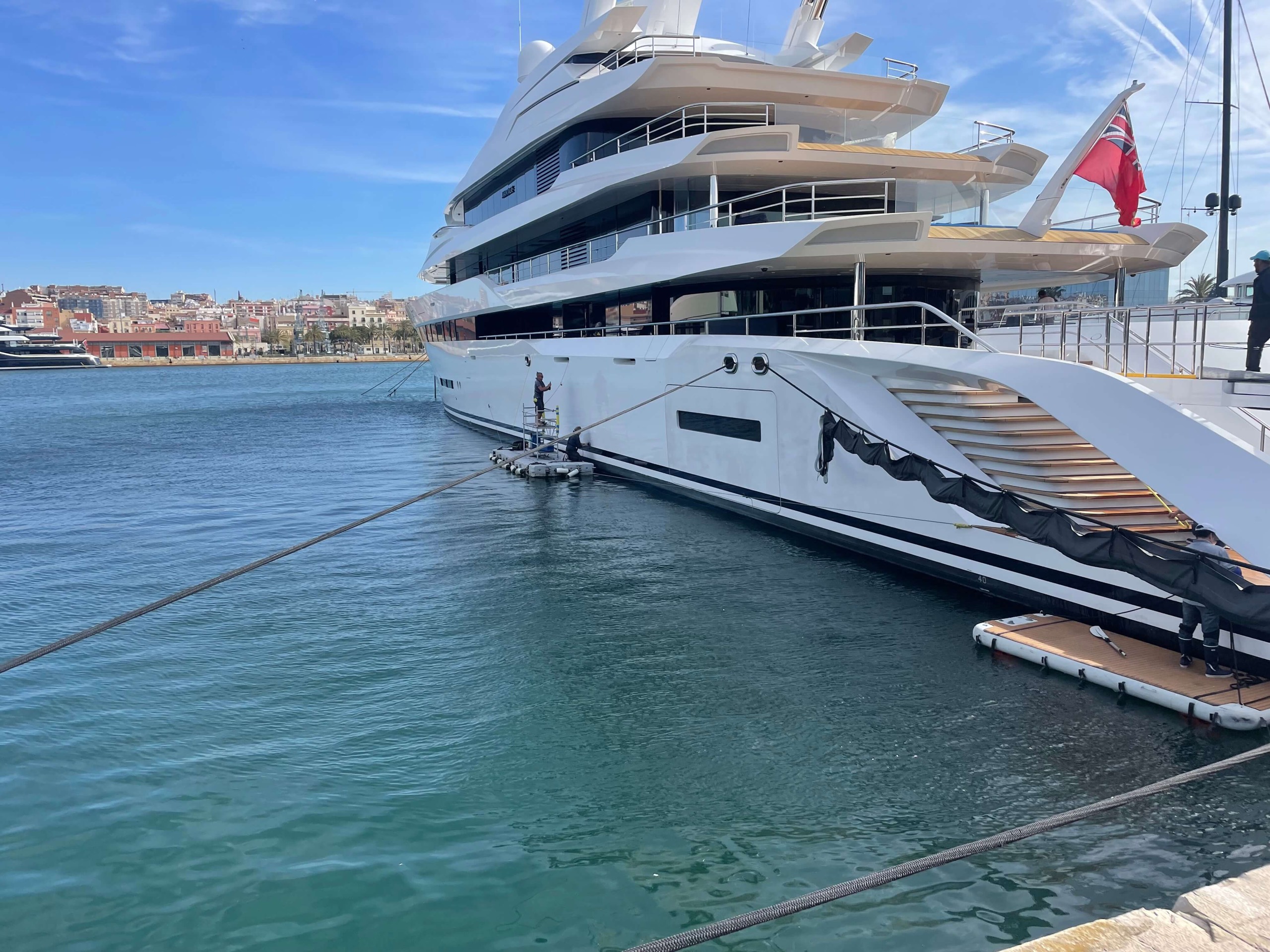 The 55m Heesen alongside in Barcelona, with the RMP Marine team working from a floating platform.