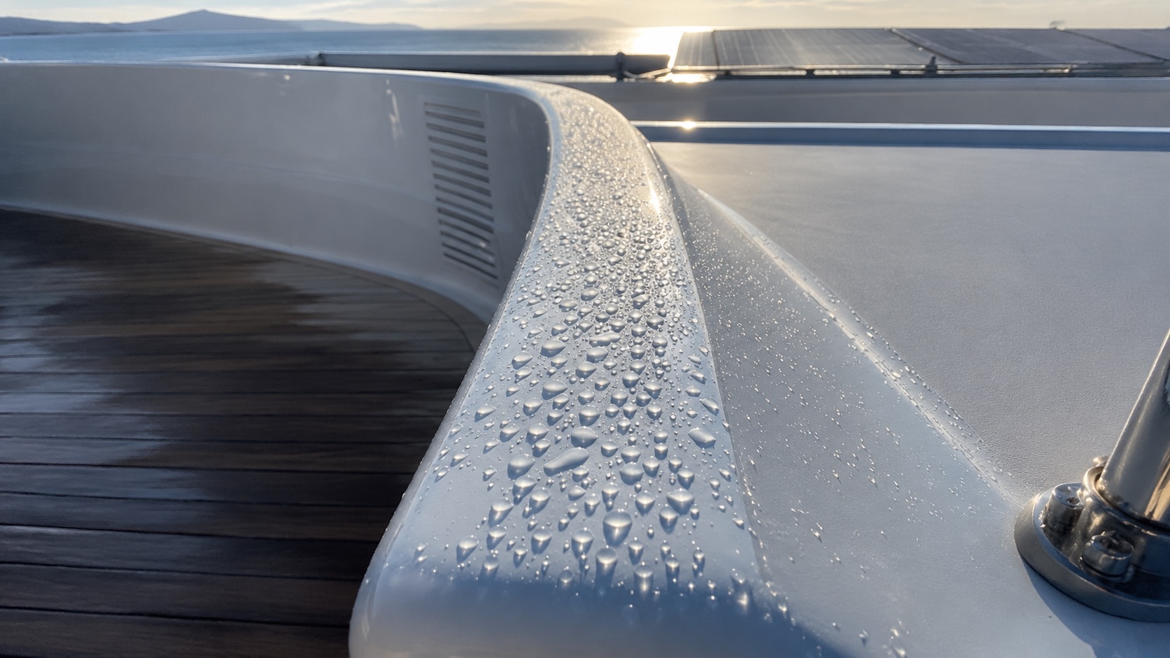 Water beading on an AGlaze-protected superyacht surface.